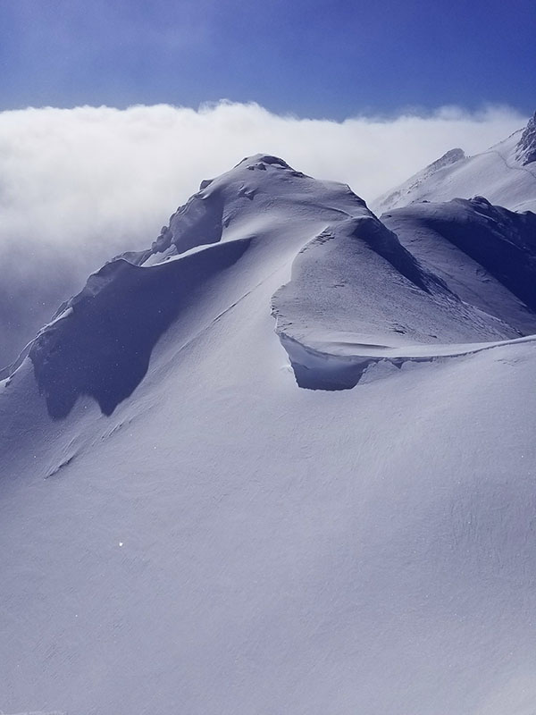 an alpine mountain top in british columbia while ski touring