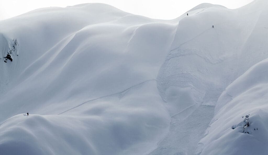 a mountain slope with an avalanche coming down the gulley