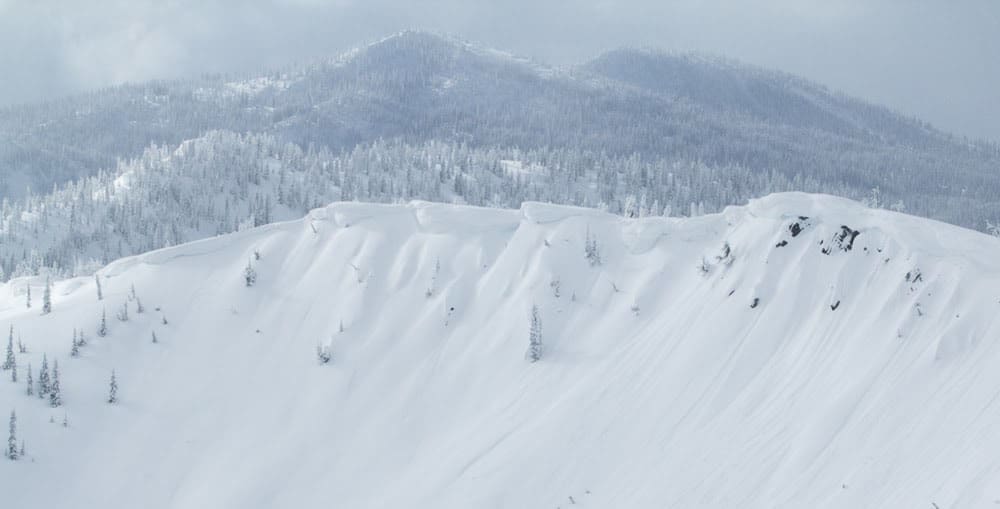 a ridge of with cornice activity on the lee slope, taken near mccall, idaho