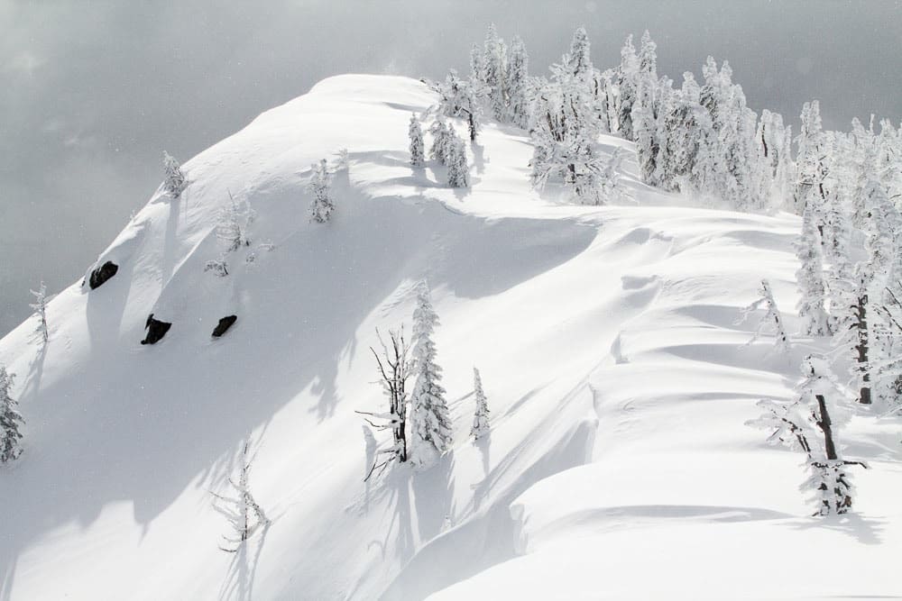 a closeup wof a ridgetop with cornice activity on the lee slope