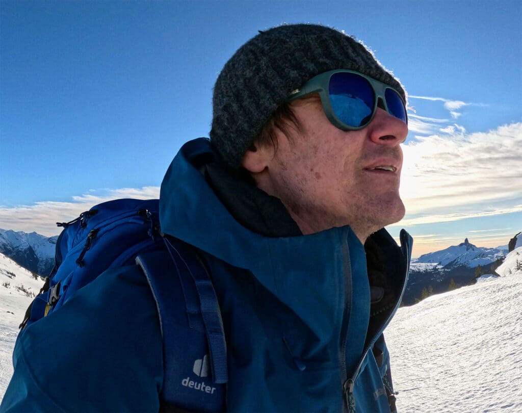 a splitboarder skins up whistler mountain while wearing the selkirk glacier sunglasses