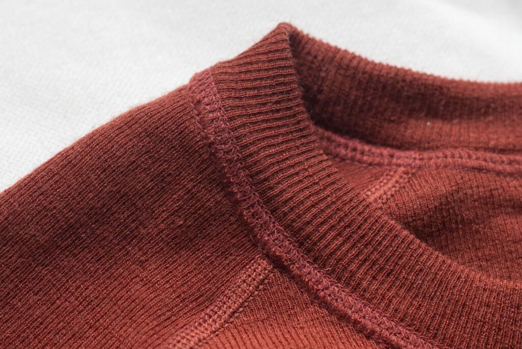 a close up of the alpaca wool stitching on the Paka base layer 