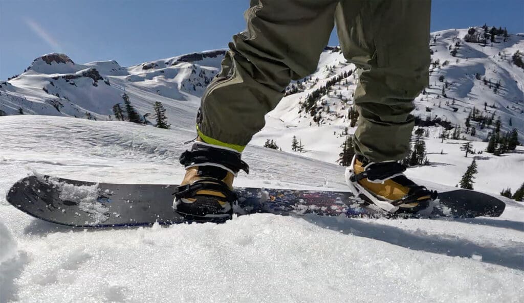 a snowboarder rides down the mountain in the mount baker backcountry while testing snowbaord bindings