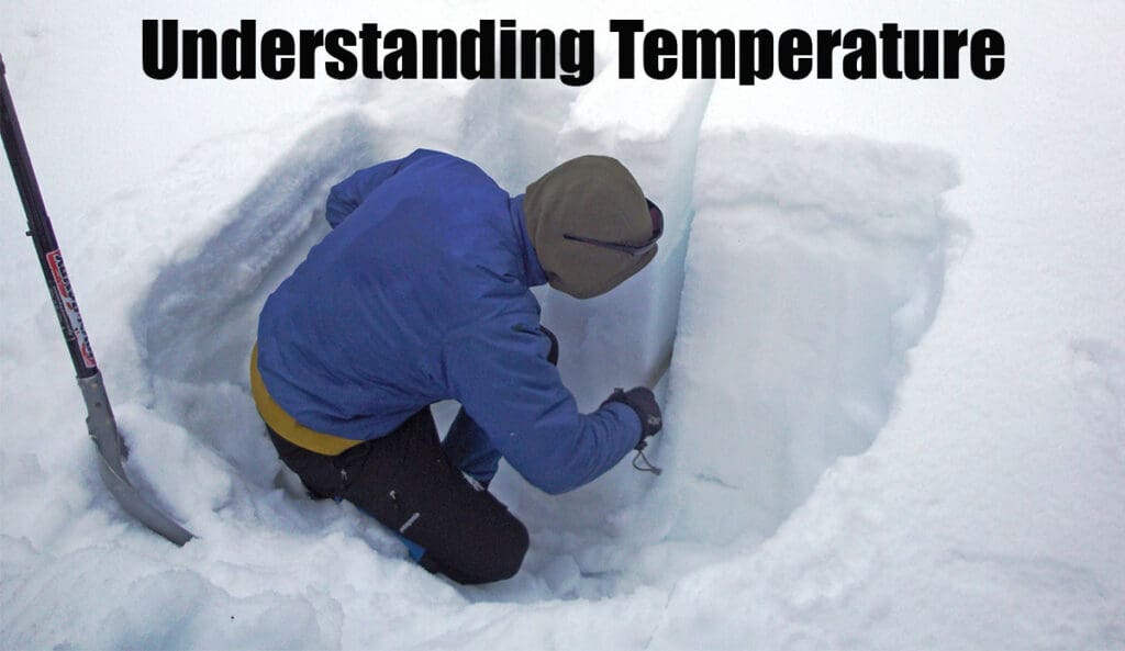 a man looks into a snow pit to determine the safety of the snowpack