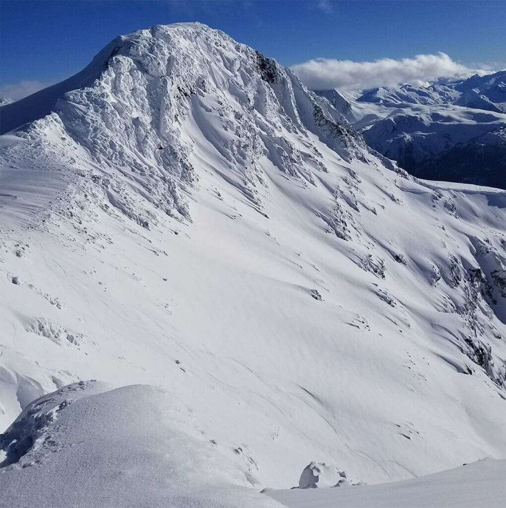 a view of blackcomb mountain in the winter with a wind effected slope