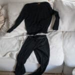 The icebreaker 200 oasis merino wool base layer spread out on a couch