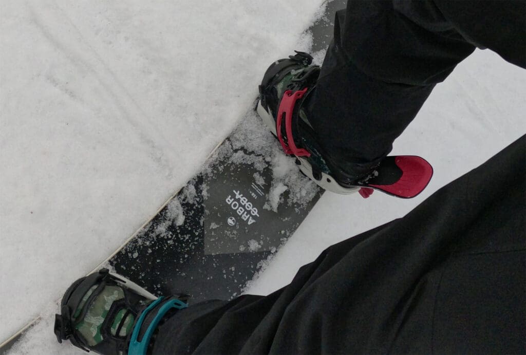 a snowboarder stepping into his FASE bindings by ThirtyTwo