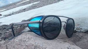 the vuarnet glacier glasses sitting on a rock in front of a snow field