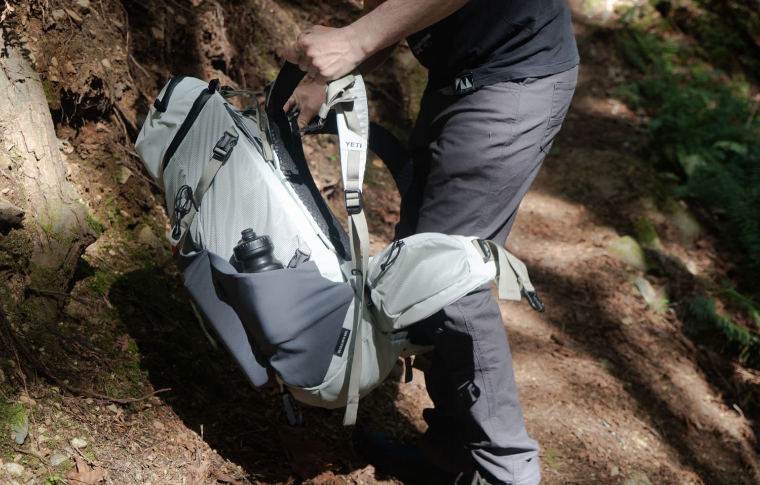 adjusting the harness on the Yeti Skala 40L backpack on the trail