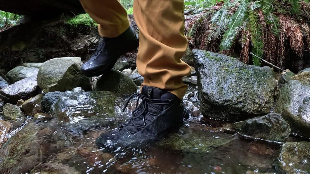 a pair of hiking boots get submerged while testing out the waterproofing in a moving creek