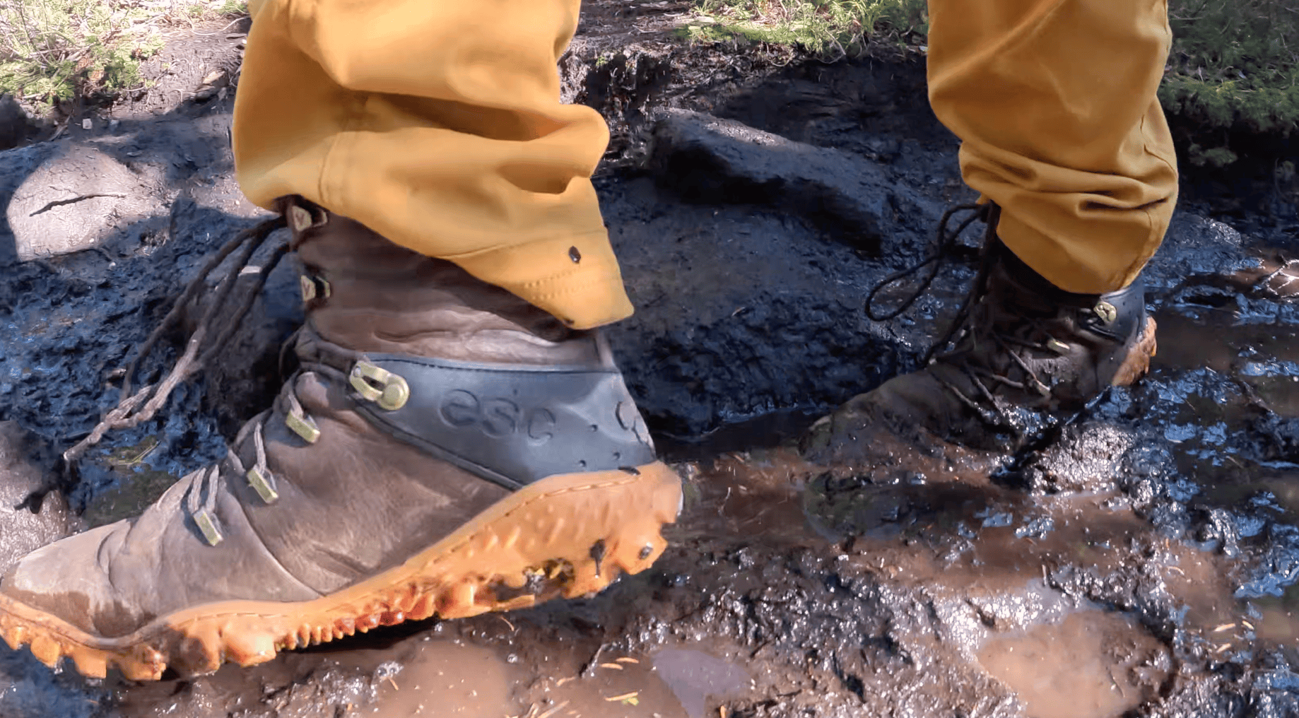 a photo of the vivobarefoot tracker forest esc boots in the mud
