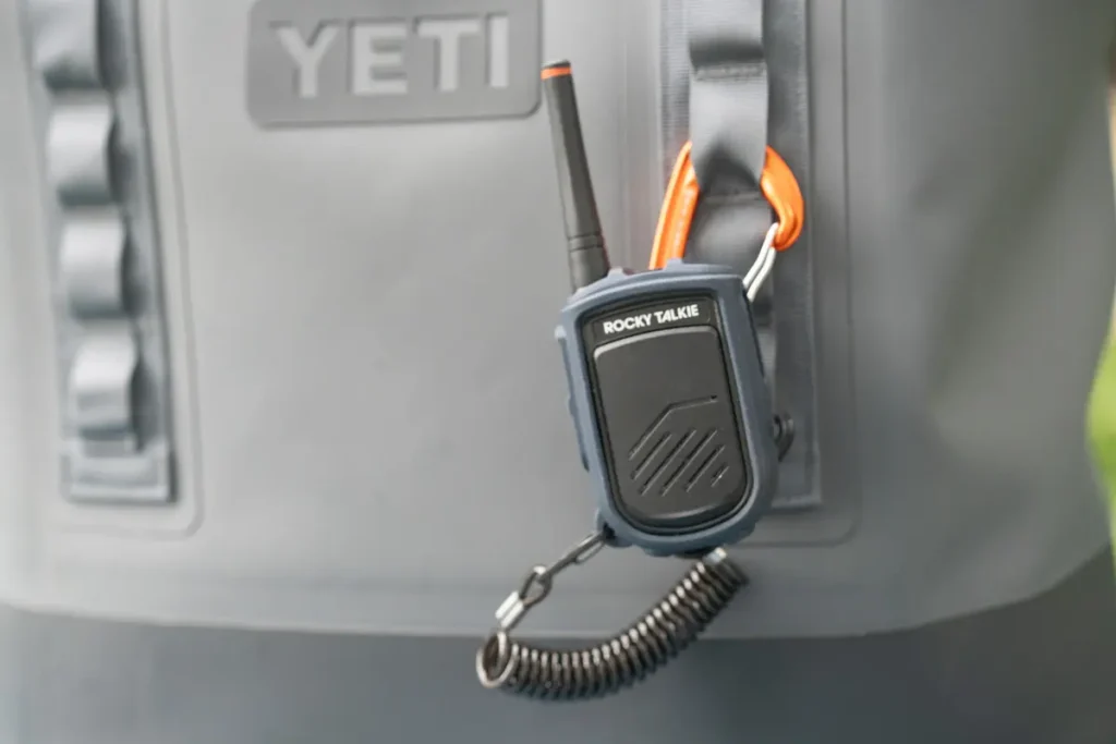 a rocky talkie mountain radio clipped to a yeti camino carryall tote