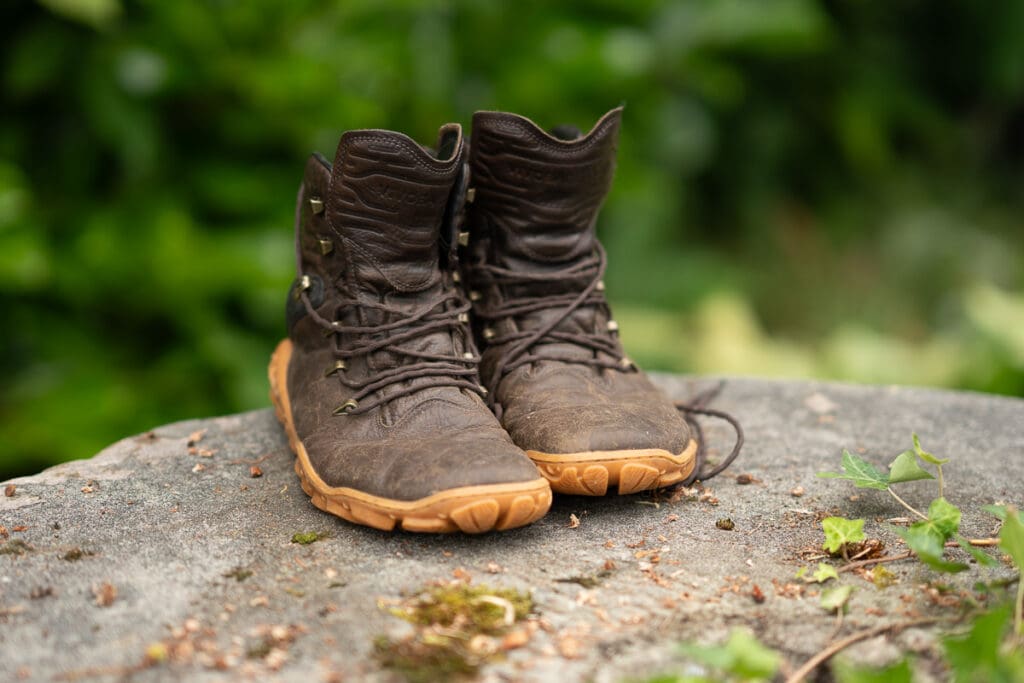 a pair of VivoBarefoot Tracker Forest ESC hiking boots set up on a stone for a picture