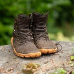 a pair of VivoBarefoot Tracker Forest ESC hiking boots set up on a stone for a picture