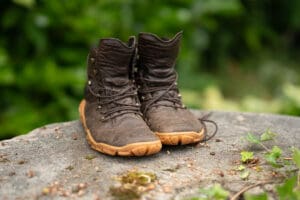 a pair of VivoBarefoot Tracker Forest ESC hiking boots set up on a stone for a picture