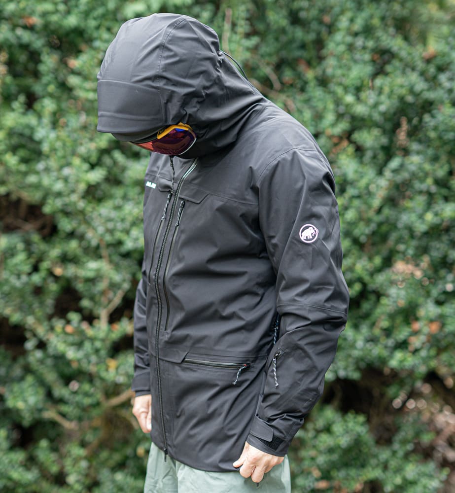 a model wears the mammut haldigrat jacket looking down with a helmet