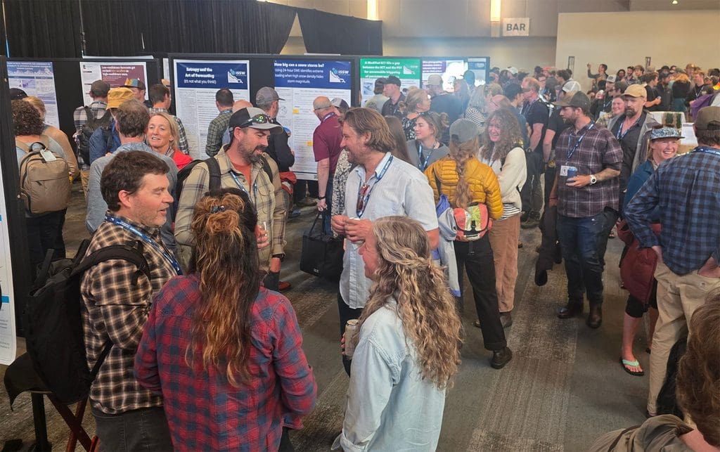 a crowd of people talk at the foyer of the whistler conference center for issw 2026