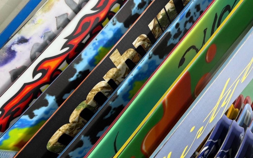 a set of Thirtytwo snowboards showing their base graphic stacked together