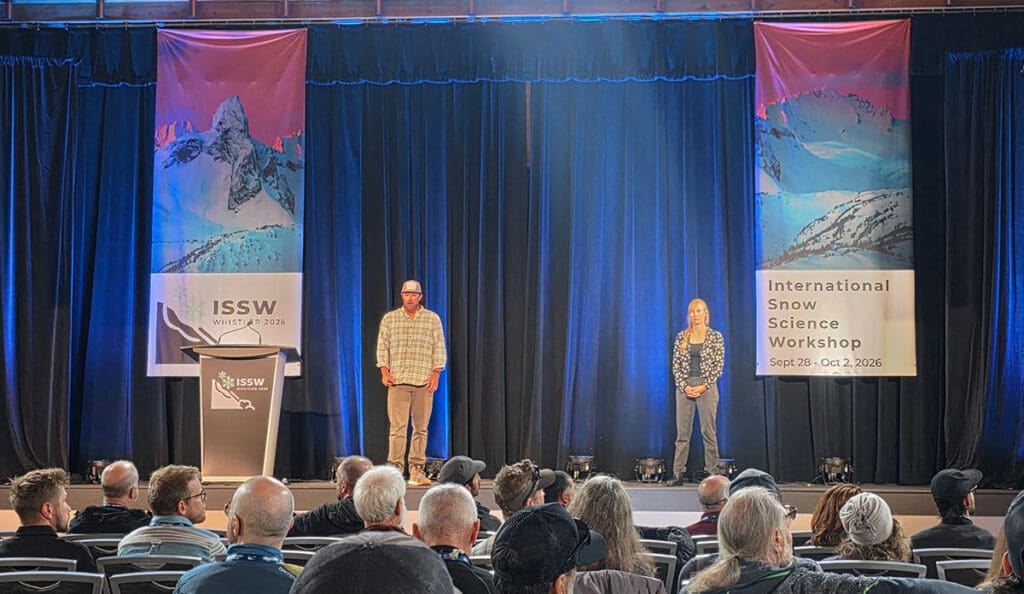 two speakers on the stage of the international snow science workshop in Whistler BC Canada