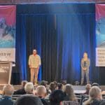 two speakers on the stage of the international snow science workshop in Whistler BC Canada